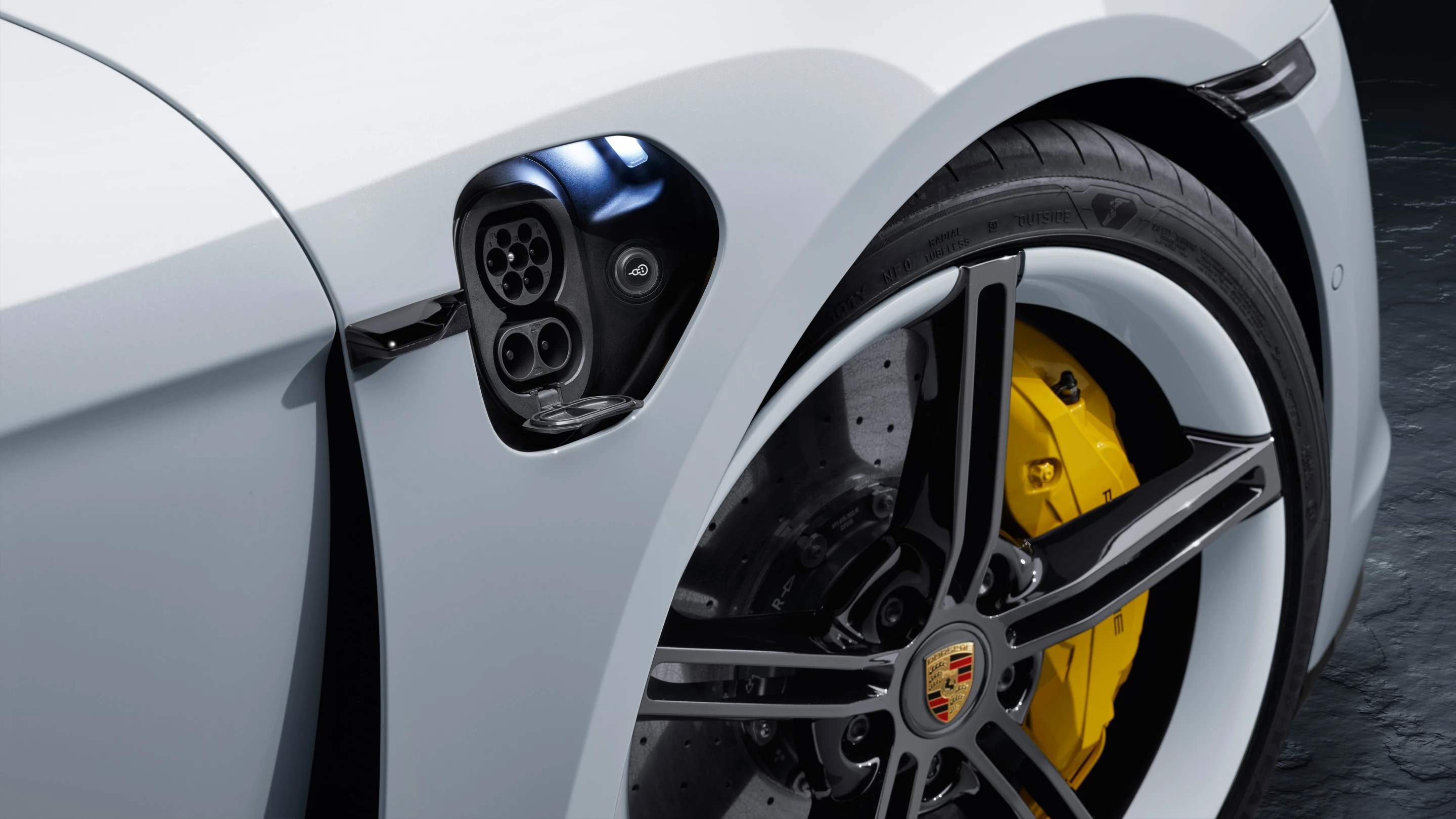 The charge port door retracts with a saucy flip of your finger under the black tab beside it