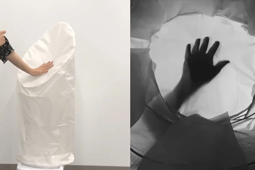 The ShadowSense prototype "sees" the shadow of a user's hand (right) as they touch the robot's skin