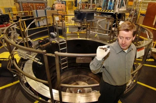 Sandia researcher Marcus Knudson considers his favorite apparatus: the Z insert that sends flyer plates hurling at phenomenal speeds. (Photo by Randy Montoya)