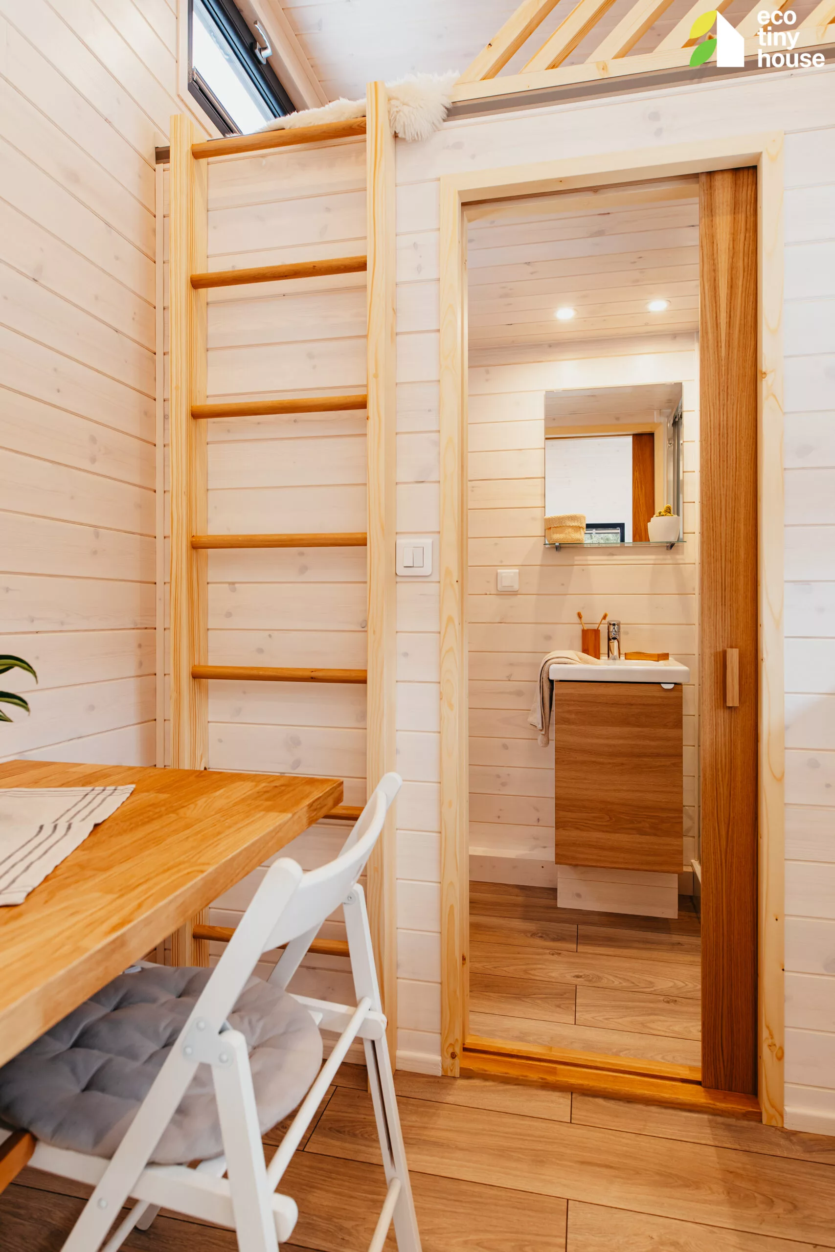 The Tiny Rubik's bathroom is accessed by a pocket sliding door from the kitchen