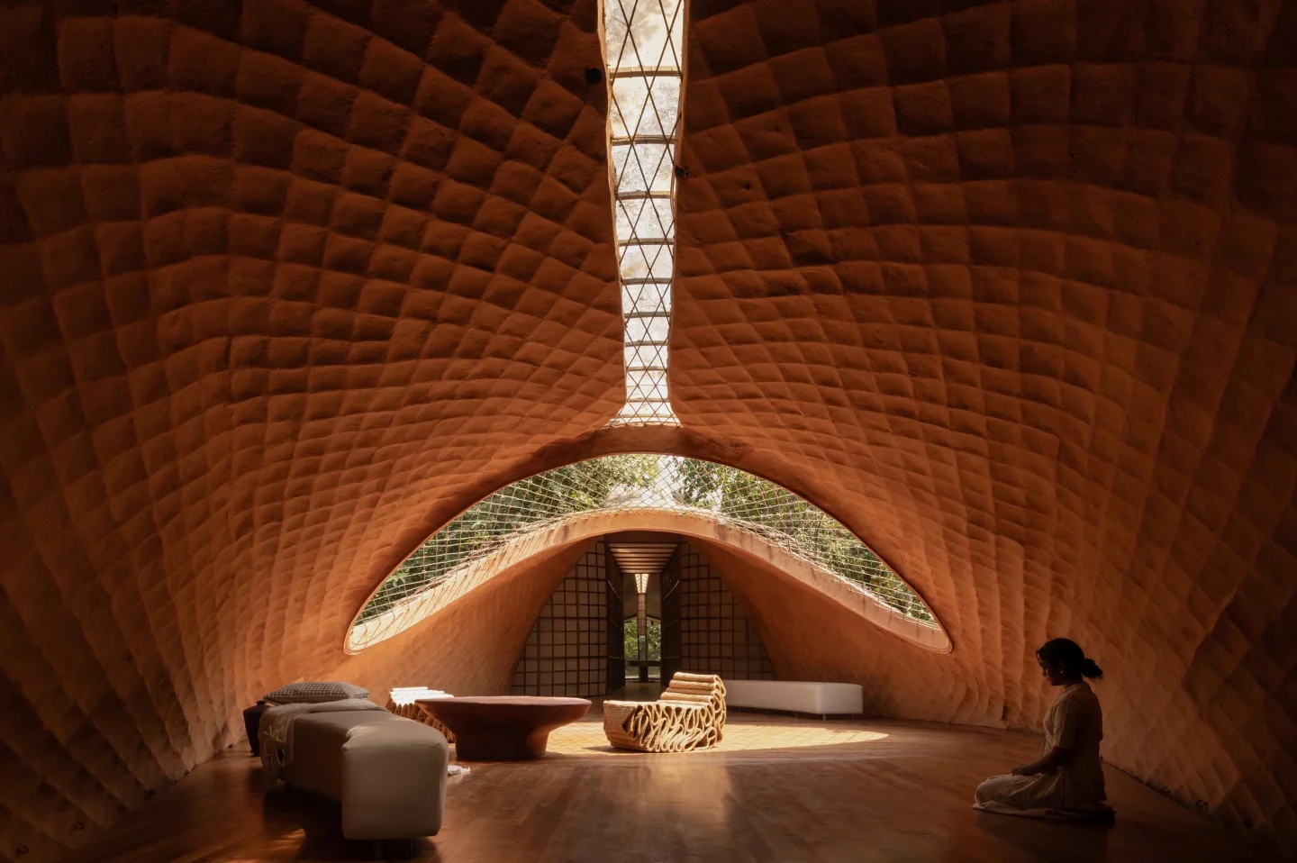 "The thatch layer inspired by the scales of a pangolin, providing thermal insulation and effective cooling also allowed us to push for a long-span, lightweight structure with just 4 footings, ensuring very less intrusion into the natural contour of the land"