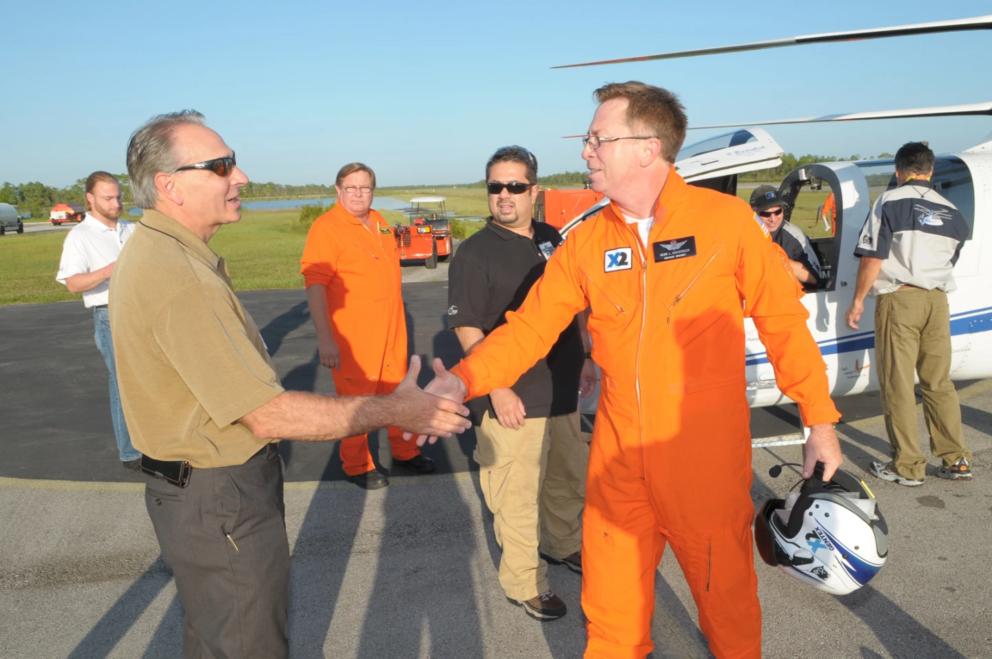 Sikorsky President Jeffrey Pino (left) shakes hands with Chief Pilot Kevin Bredenbeck after the flight