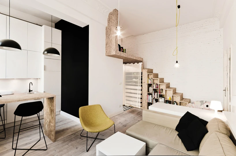 The designers fitted a bed area over a wardrobe, accessible via a small wooden staircase