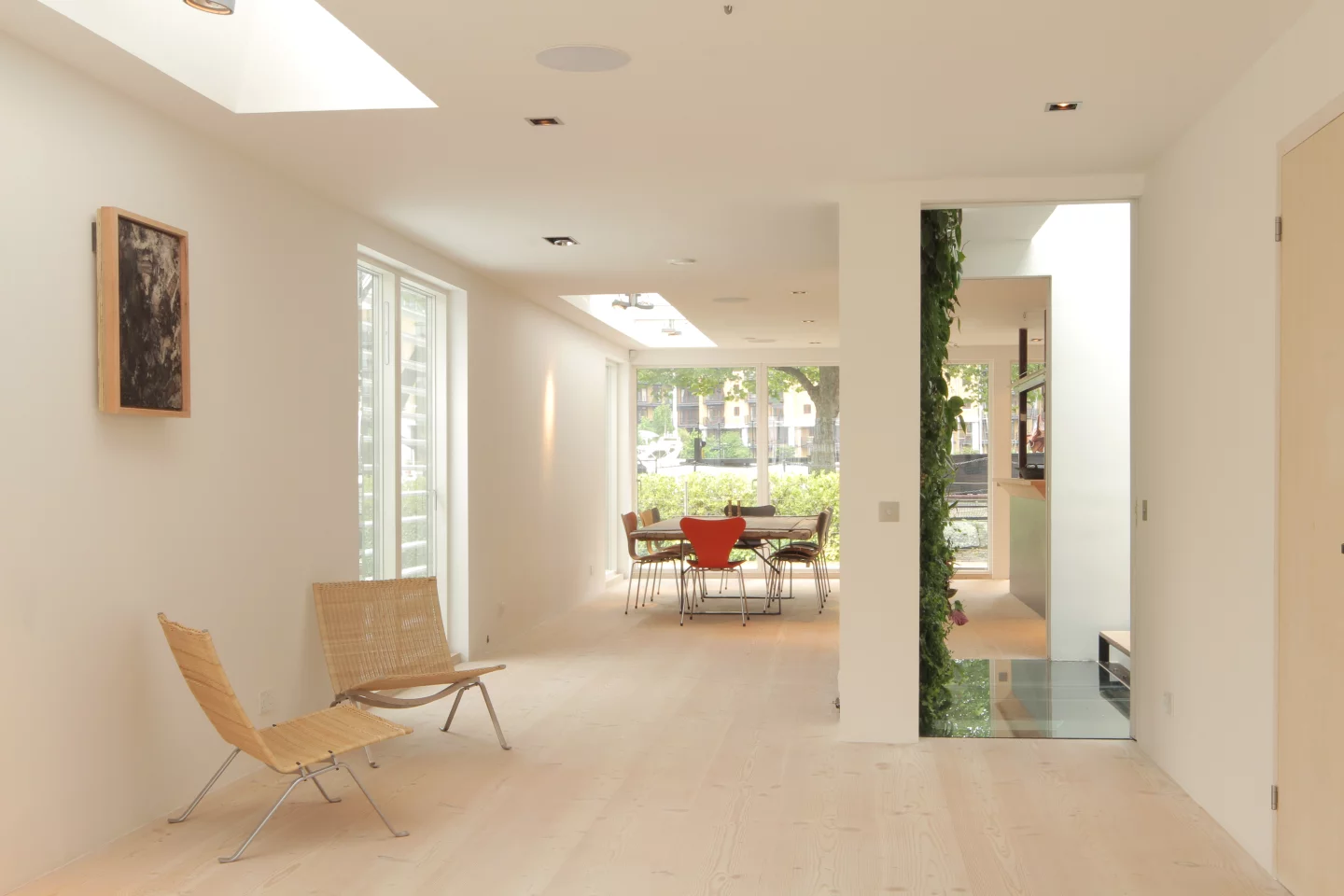 The multifunctional entrance area and staircase features an impressive green wall