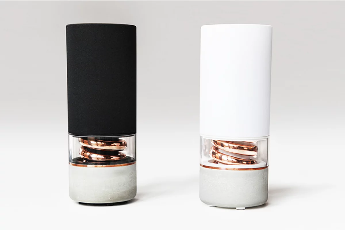 The Pavilion Bluetooth speaker features a high density concrete base, a copper spiral bass port and an American white oak top with indented touch-enabled control buttons