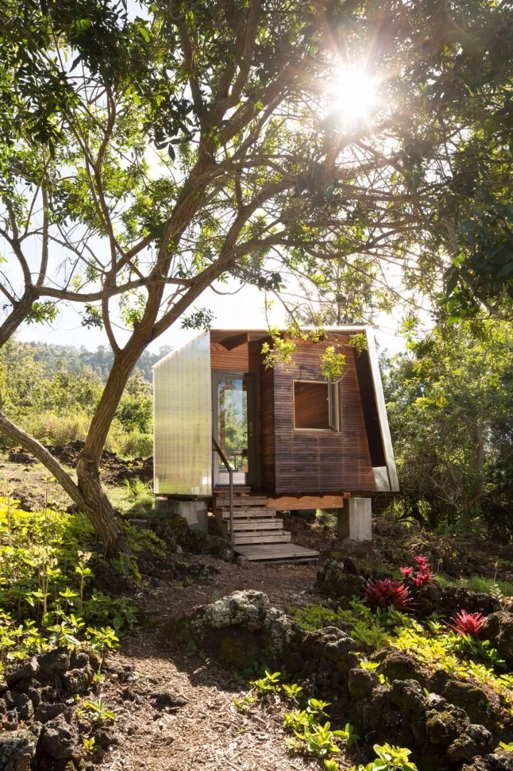 Tiny house designer Erin Moore has realized the construction of two dwellings amid a 300 year old solidified lava landscape in Hawaii