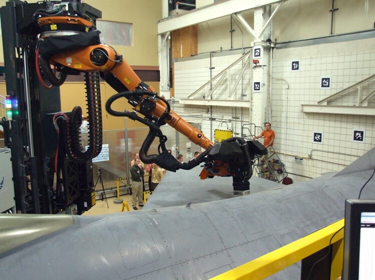 Prototype robots autonomously strip paint from aircraft using lasers