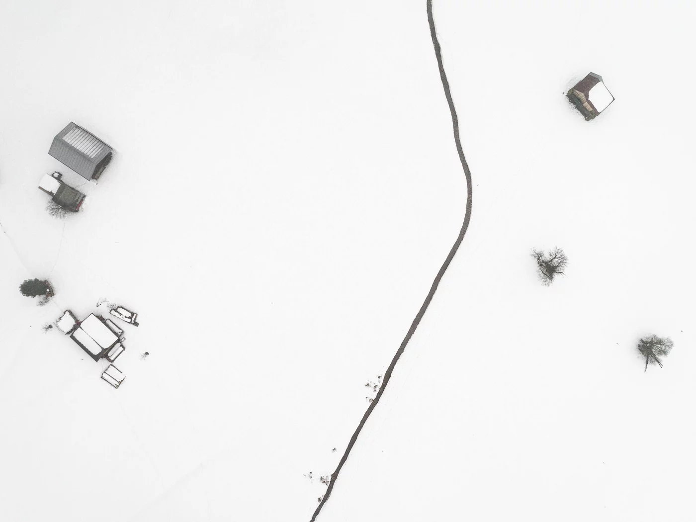 The Farmland Series: A look at farmland during winter in the Allgaeu Alps, a pre-alpine region in Germany. These open landscapes become dusted with white snow leaving only the human farming traces to stand out