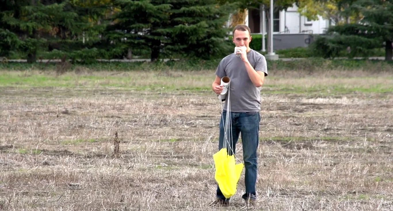 The canister holds and protects a 500 gram burrito and deploys an attached parachute when dropped, so the contents arrive in one edible piece at their destination