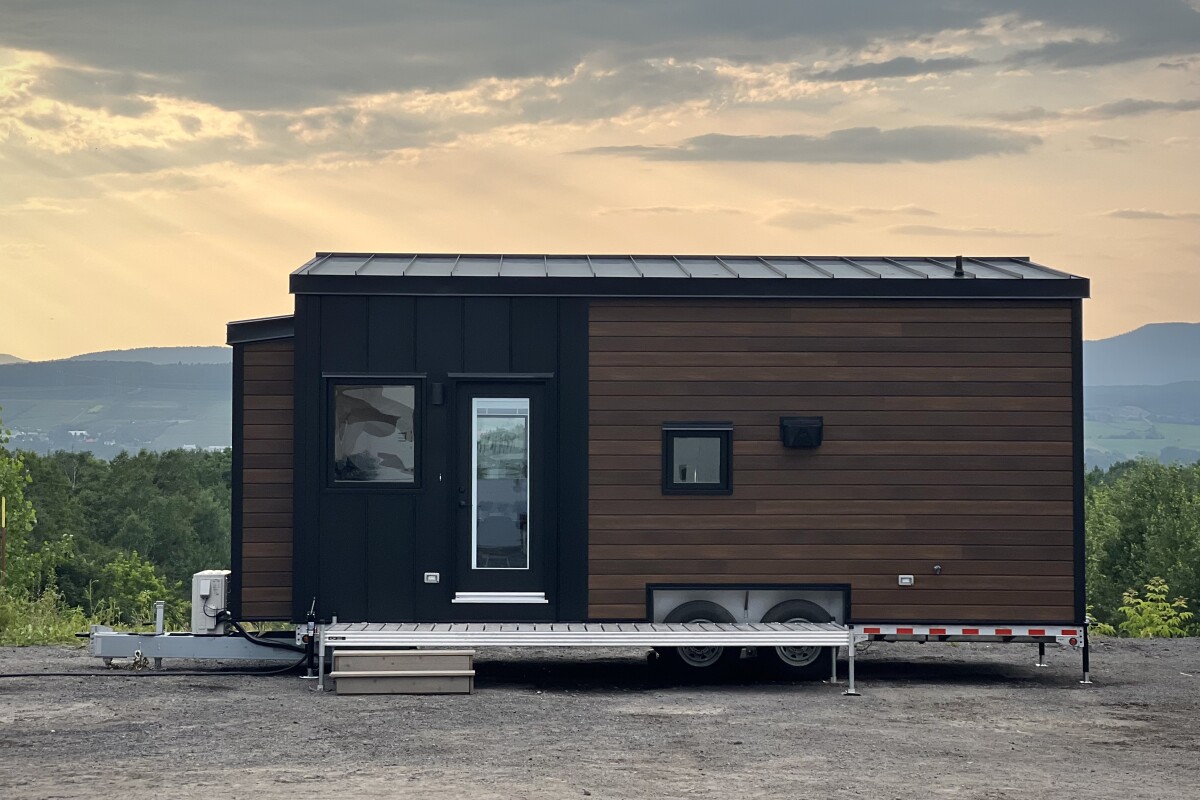 Allweather tiny house goes short and wide for more room inside