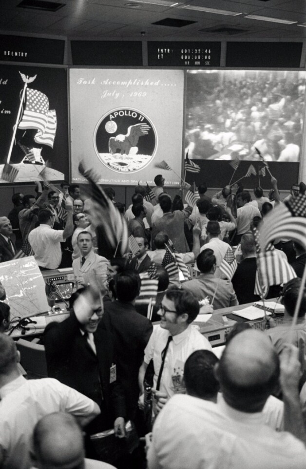Flight Controllers pictured on July 24, 1969, celebrating the successful conclusion of the Apollo 11 mission