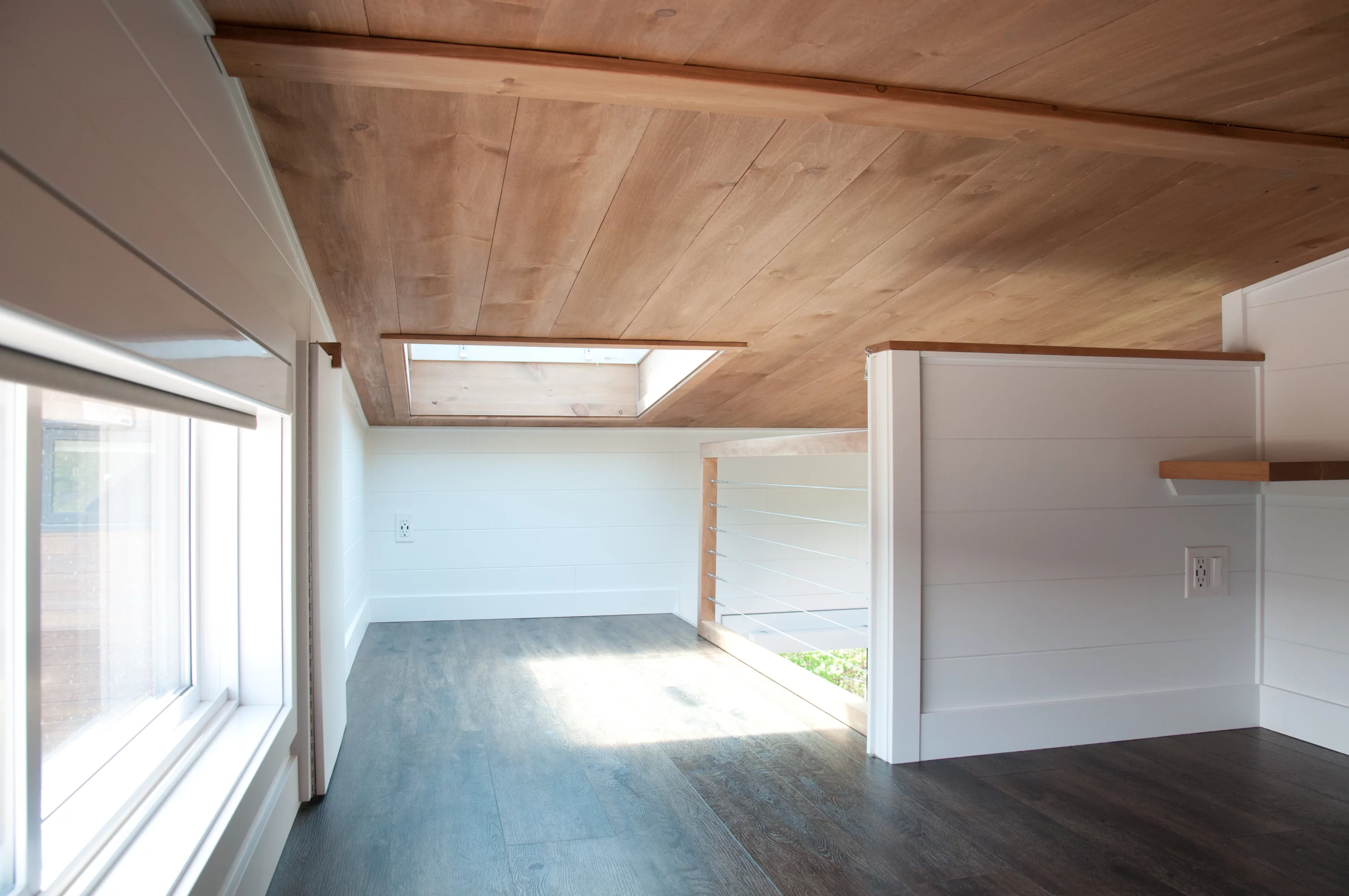 The Noyer XL V2's upstairs bedroom is a standard tiny house-style loft bedroom, and includes a skylight