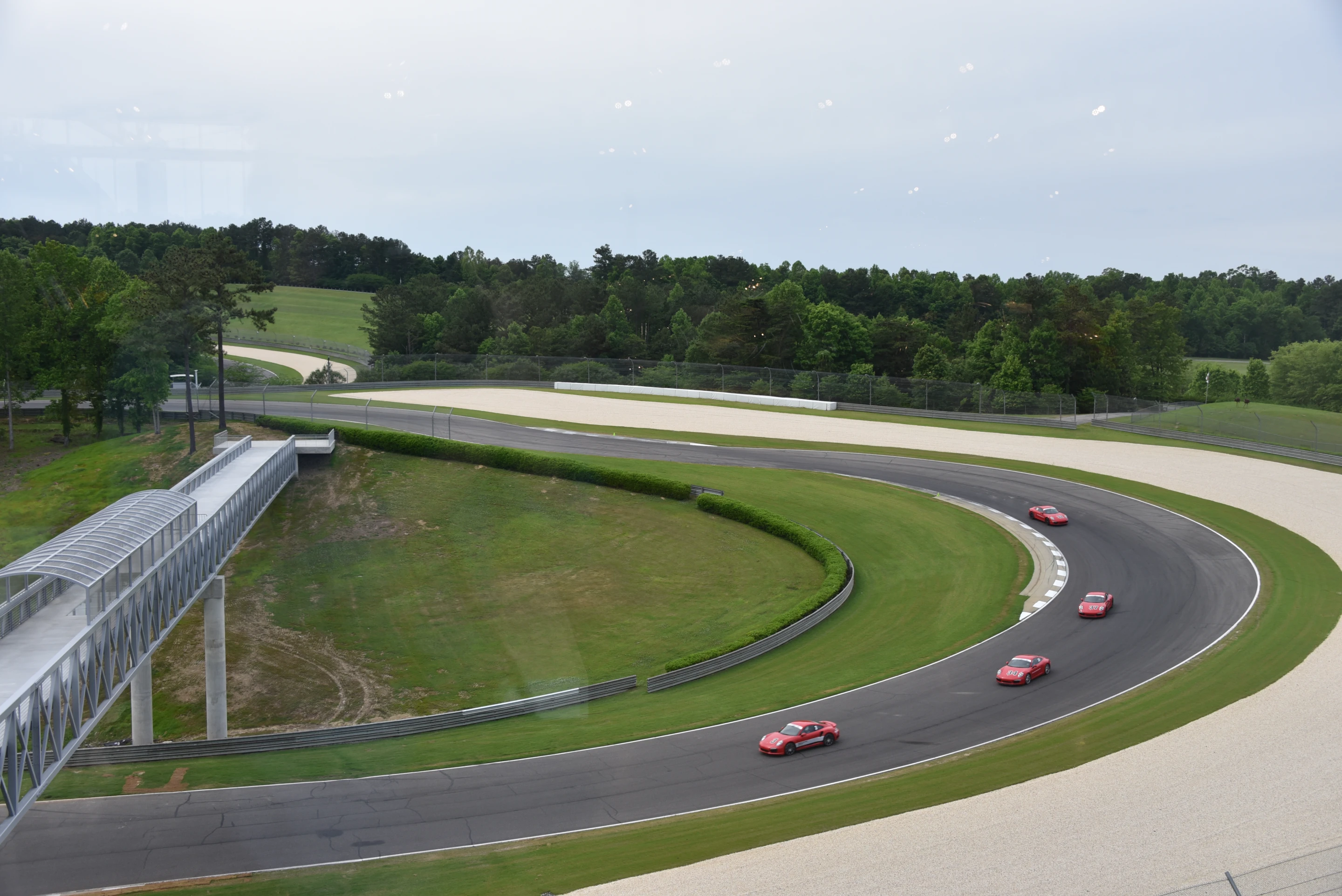 Porsche cars on track can be seen from the museum floors