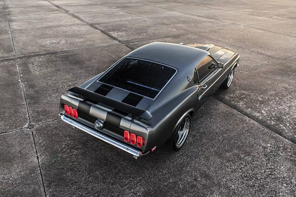 The custom paint on the 1969 Mustang Mach 1 Hitman includes Mach 1 striping and spoilers derived from the original