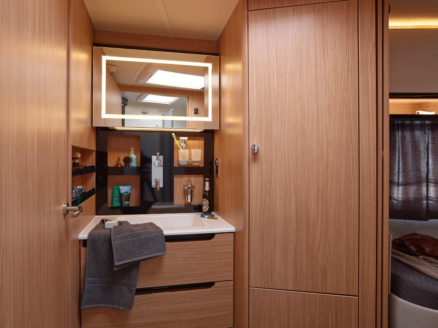 The bathroom includes a shower/toilet room and separate sink area