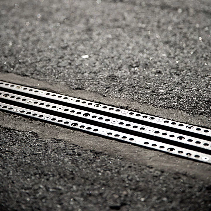 To prevent shocks, the electrified eRoadArlanda rails are earthed at the surface, with the conductor buried deep underneath