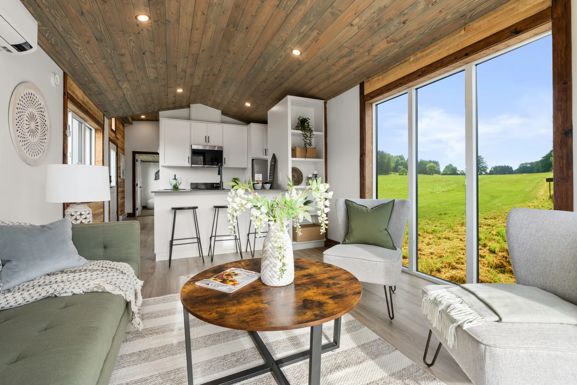 The Cypress' living room is spacious and open, with generous glazing filling the area with daylight