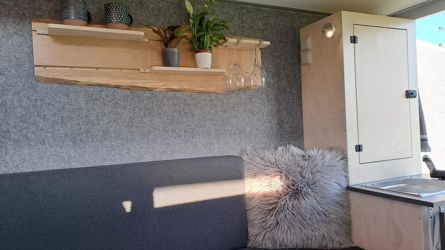 The oiled oak live-edge wood shelf and wine glass holder really enhances the rusticity of the interior