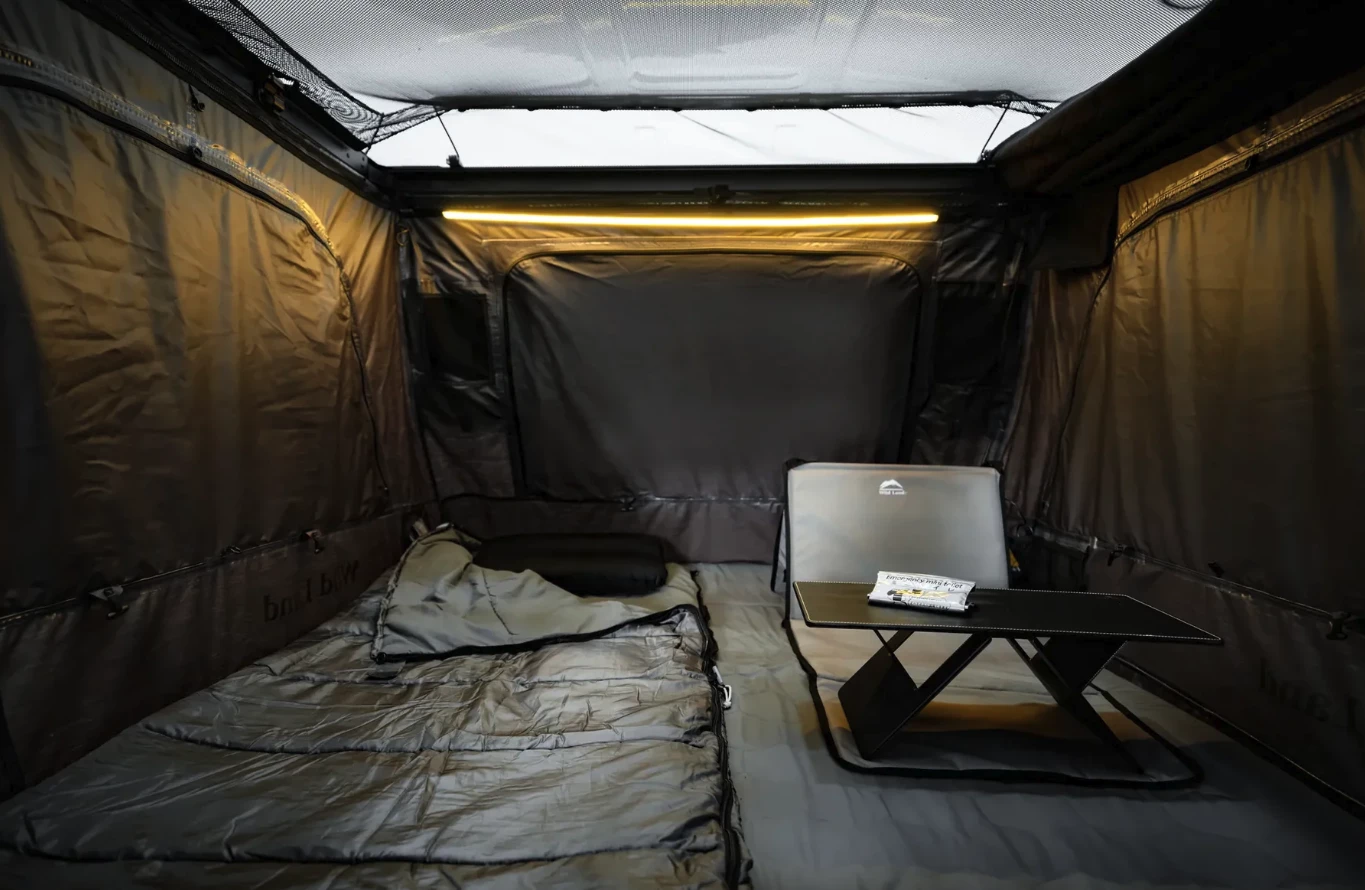 Black-out covers close up the windows and also the pictured transparent roof for when you want total darkness; also note the included folding table with Urine Bag on top and fold-up mat lounger on the right