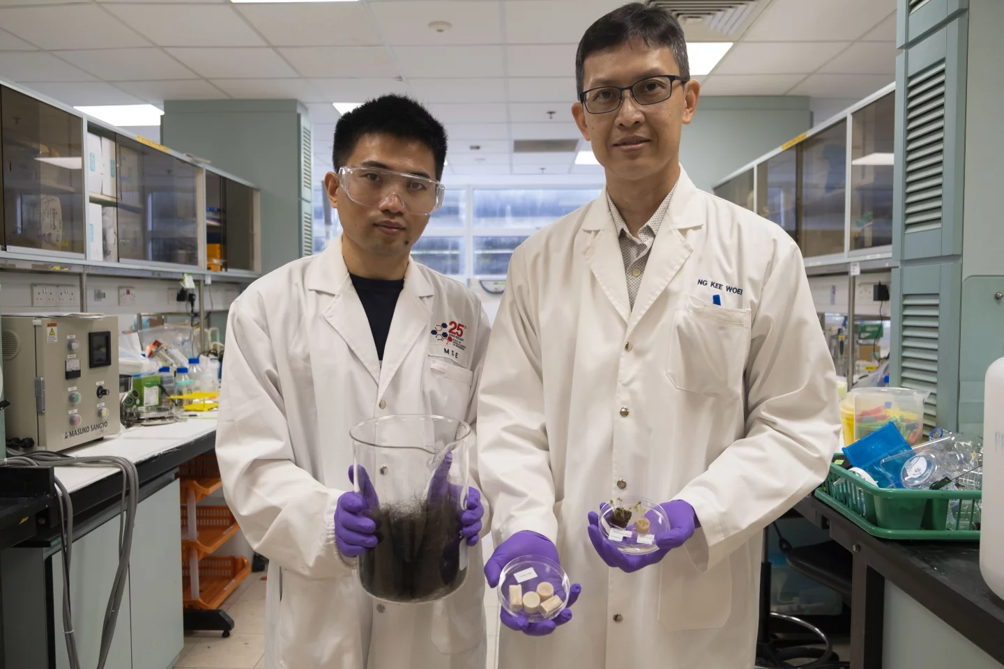 Dr. Zhao Zhitong (left) and Prof. Ng Kee Woei, displaying raw hair and the finished product