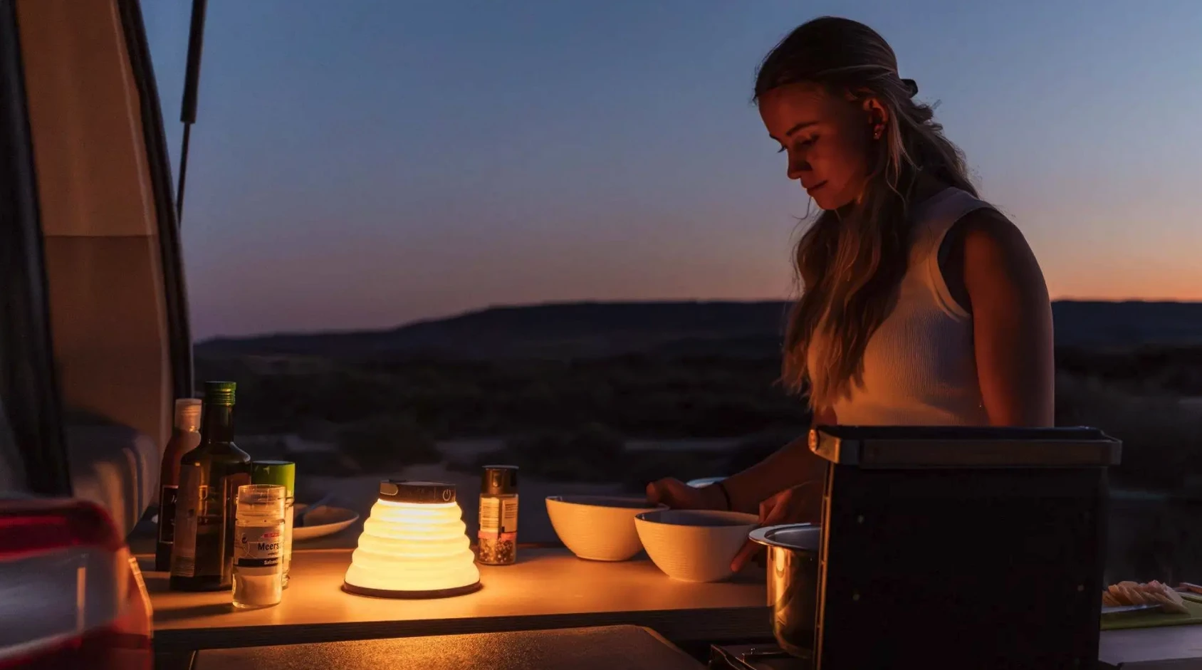 Meal prep after dark is definitely easier when you can just slide all your kitchen equipment out without having to pull out standalone camping furniture, coolers, etc.
