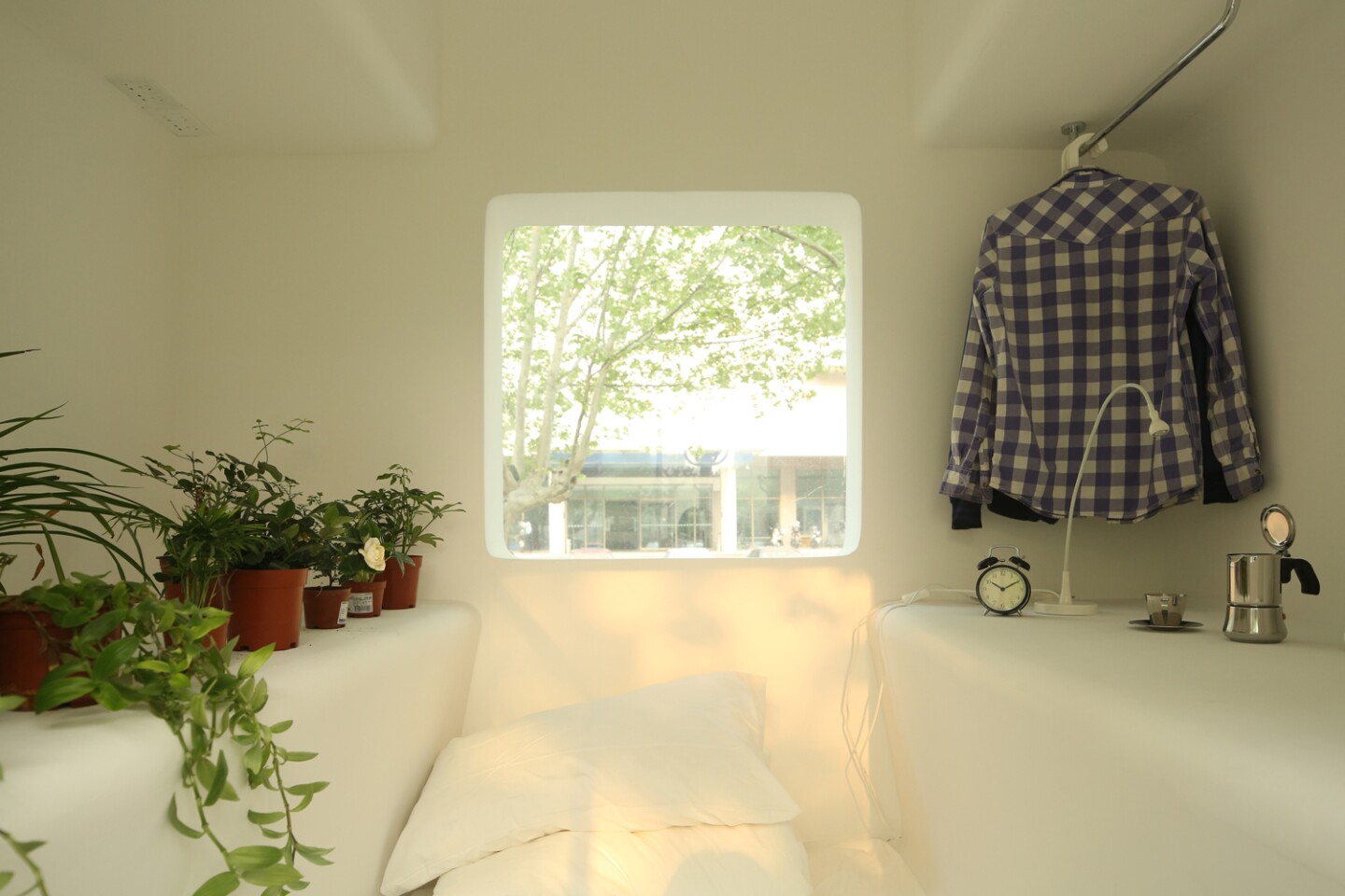 Each modular unit incorporates all interior furnishings into its main architectural structure, including bookshelves, clothes racks, seating and bedding
