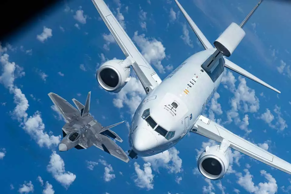An E-7 accompanied by an F-22 Raptor