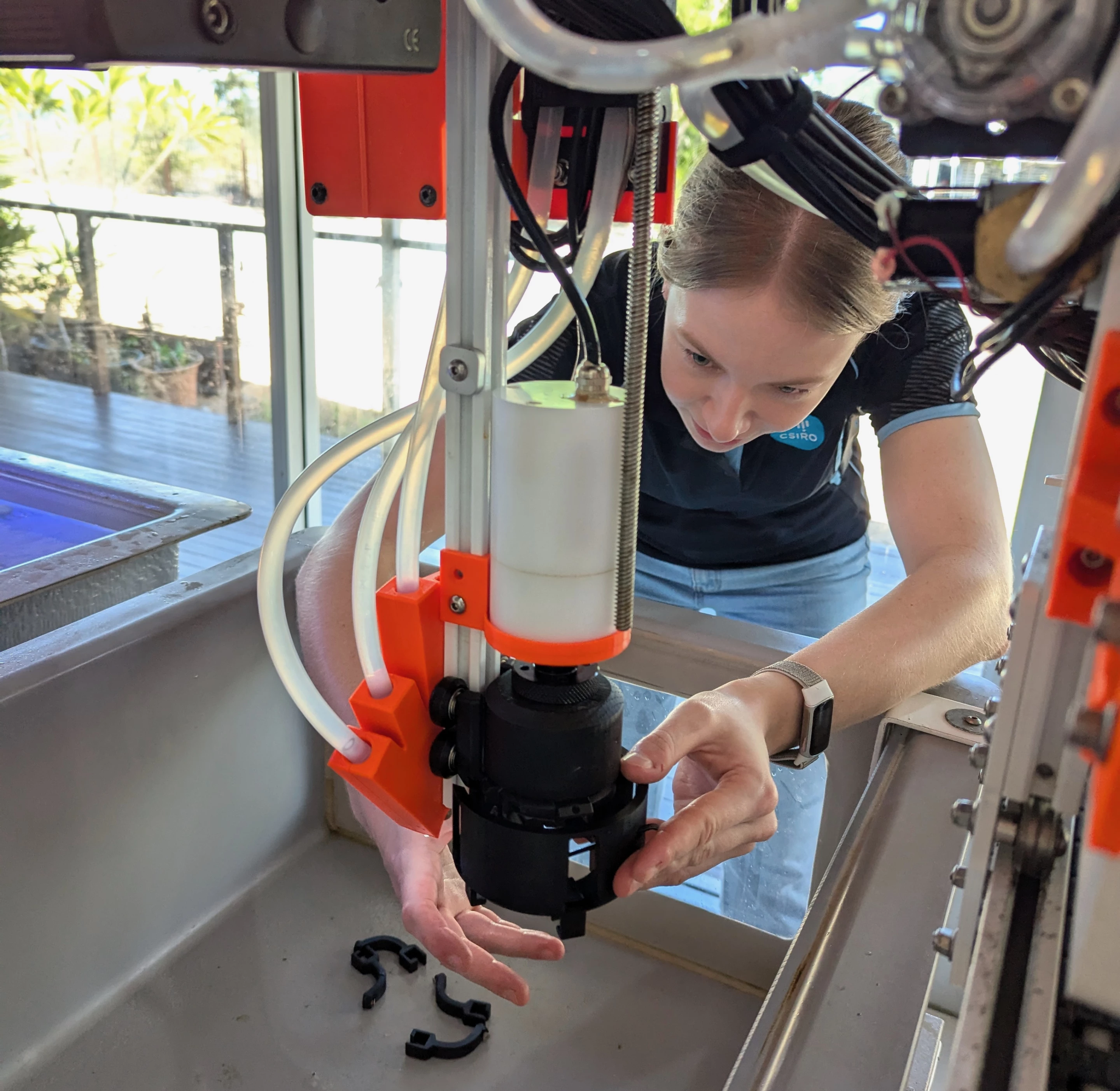 Sarah Baldwin, a Mechatronics Engineer who worked on the project while at CSIRO, fitting the hand to the CHARM robot