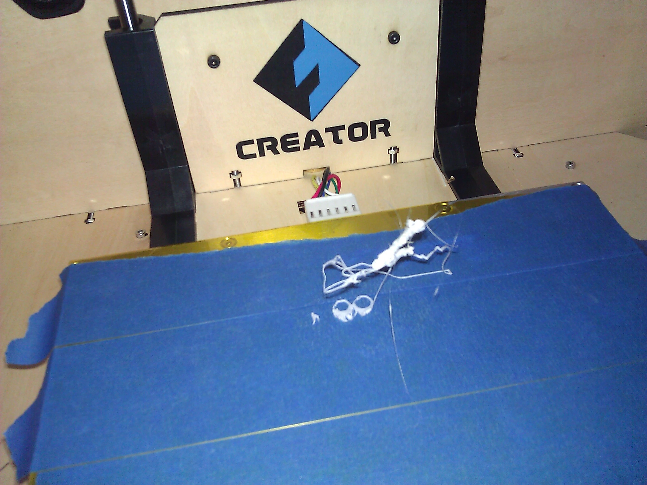 When the filament of melted plastic does not stick to the build platform, you get this artistic, but useless, glob of plastic threads I call a spider web (Photo: Gizmag)