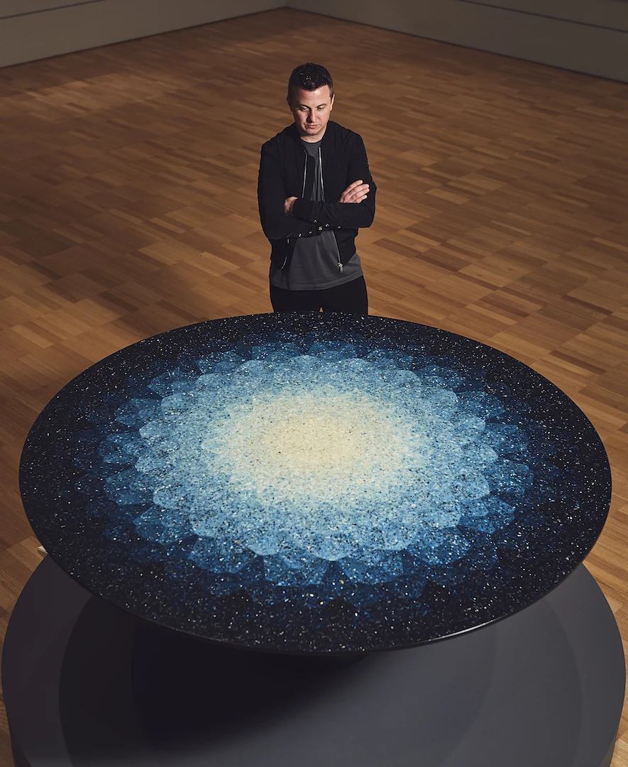 Australian designer Brodie Neill with his work Gyro, table 2016, on display in the NGV Triennial at the National Gallery of Victoria, Melbourne. The acquisition of Gyro, table 2016 is being supported by Victorian Foundation for Living Australian Artists and Mercedes - Benz Australia/Pacific.