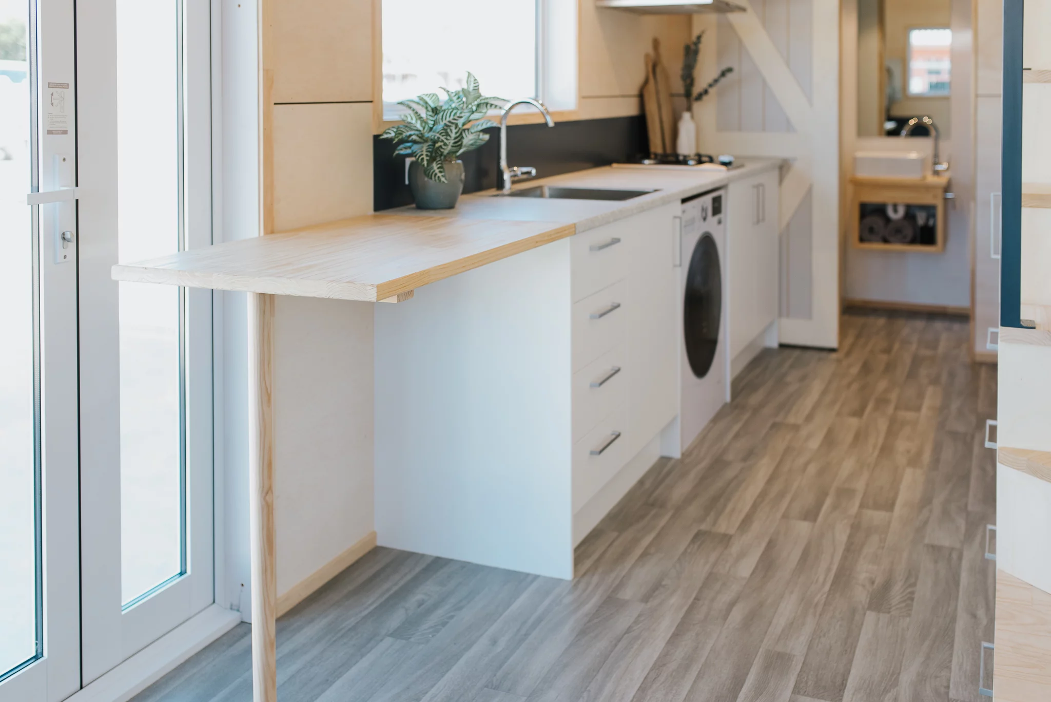 The Purple Palace's kitchen includes a folding breakfast bar that seats two people