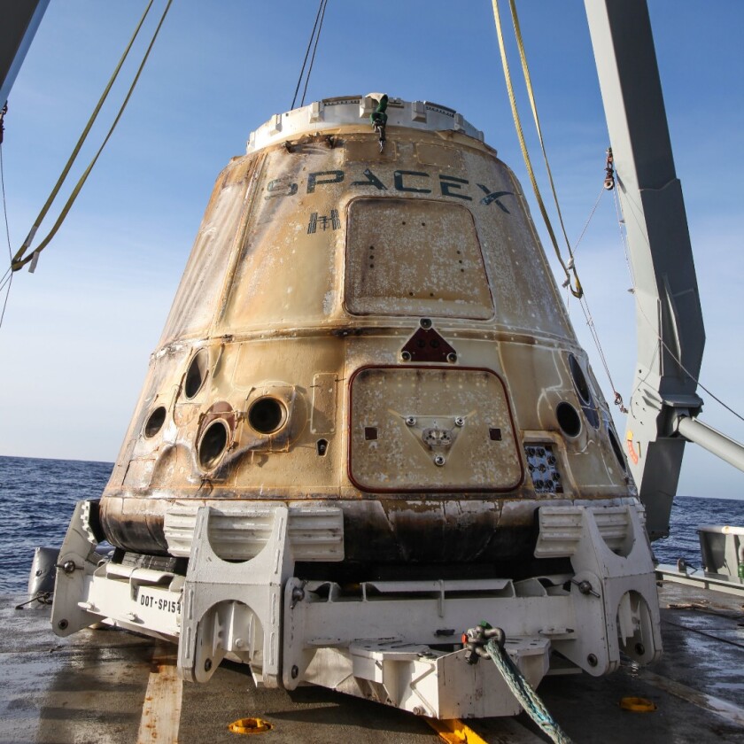 Recovered Dragon spacecraft following its safe splashdown in the Pacific Ocean