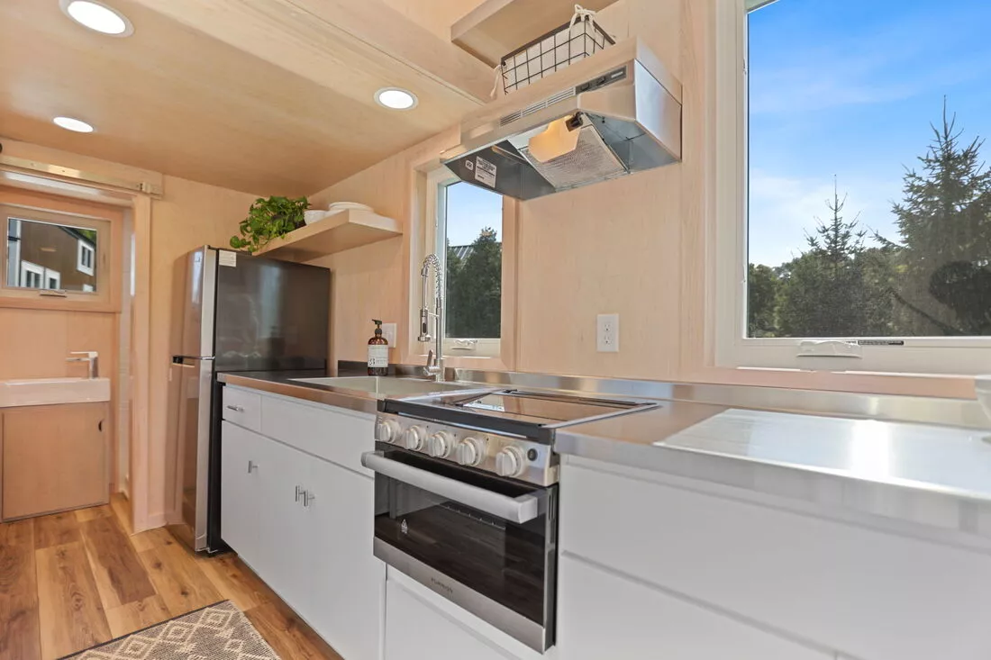The Sea Chord's kitchen includes an oven, induction cooktop, sink, fridge/freezer, and lots of cabinetry