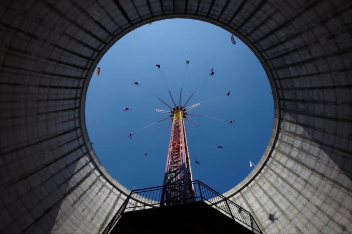 The landmark cooling tower has been fitted with a swing ride and the outer walls are used as a climbing wall (image from Wunderland Kalkar)