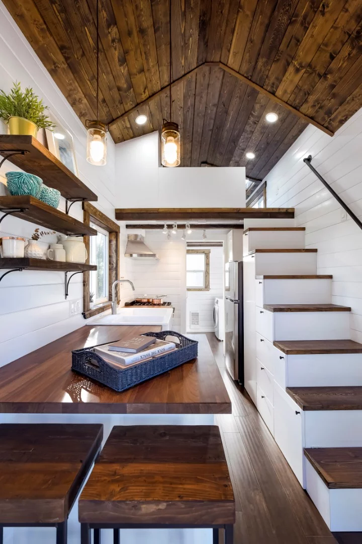There is a built-in bar table incorporated into the kitchen, with two stools that tuck away neatly beneath the kitchen bench