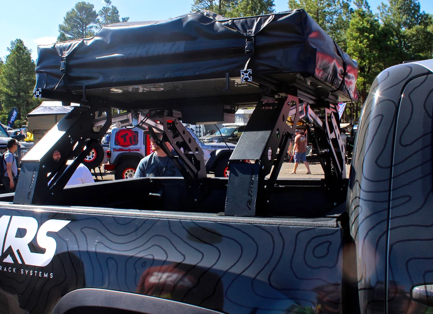 Altitude Rack Systems demonstrates its power pickup rack that raises up to provide bed access and lowers down for a lower-profile ride