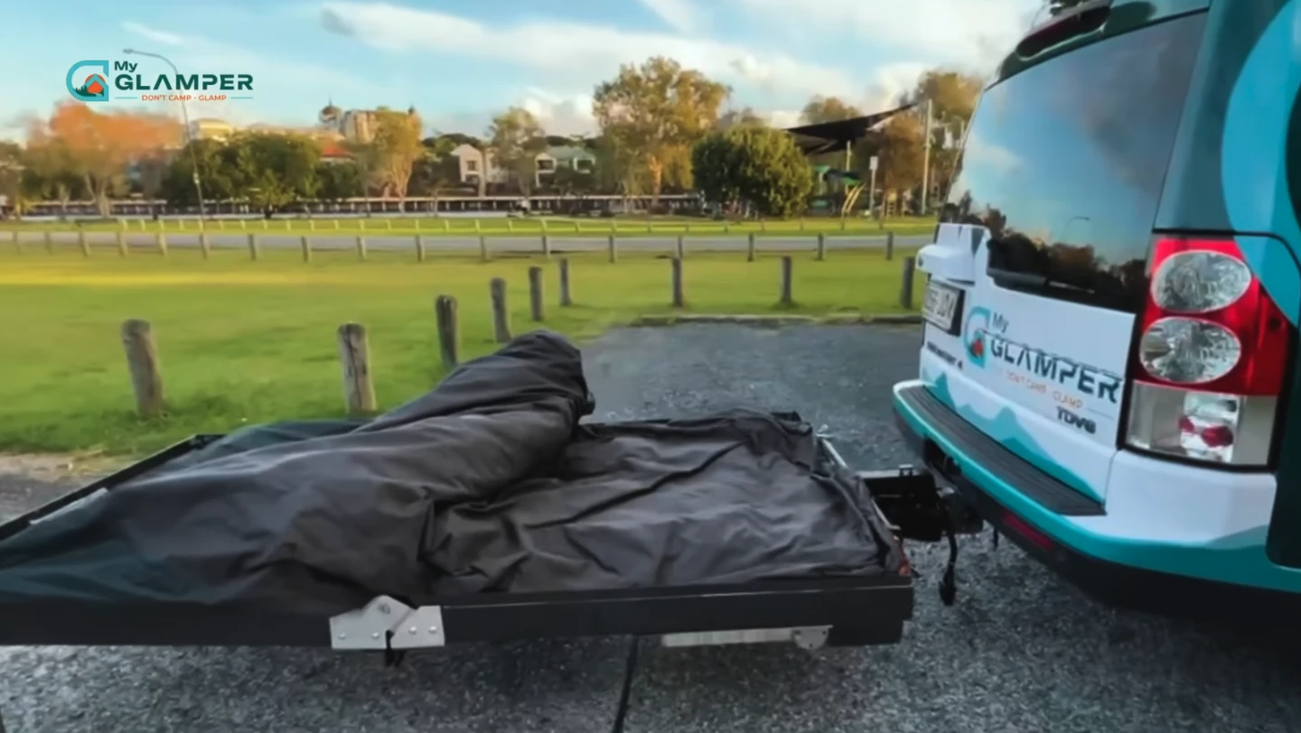 At camp, the MyGlamper lowers down to ground level and unfolds into a two-part bed floor