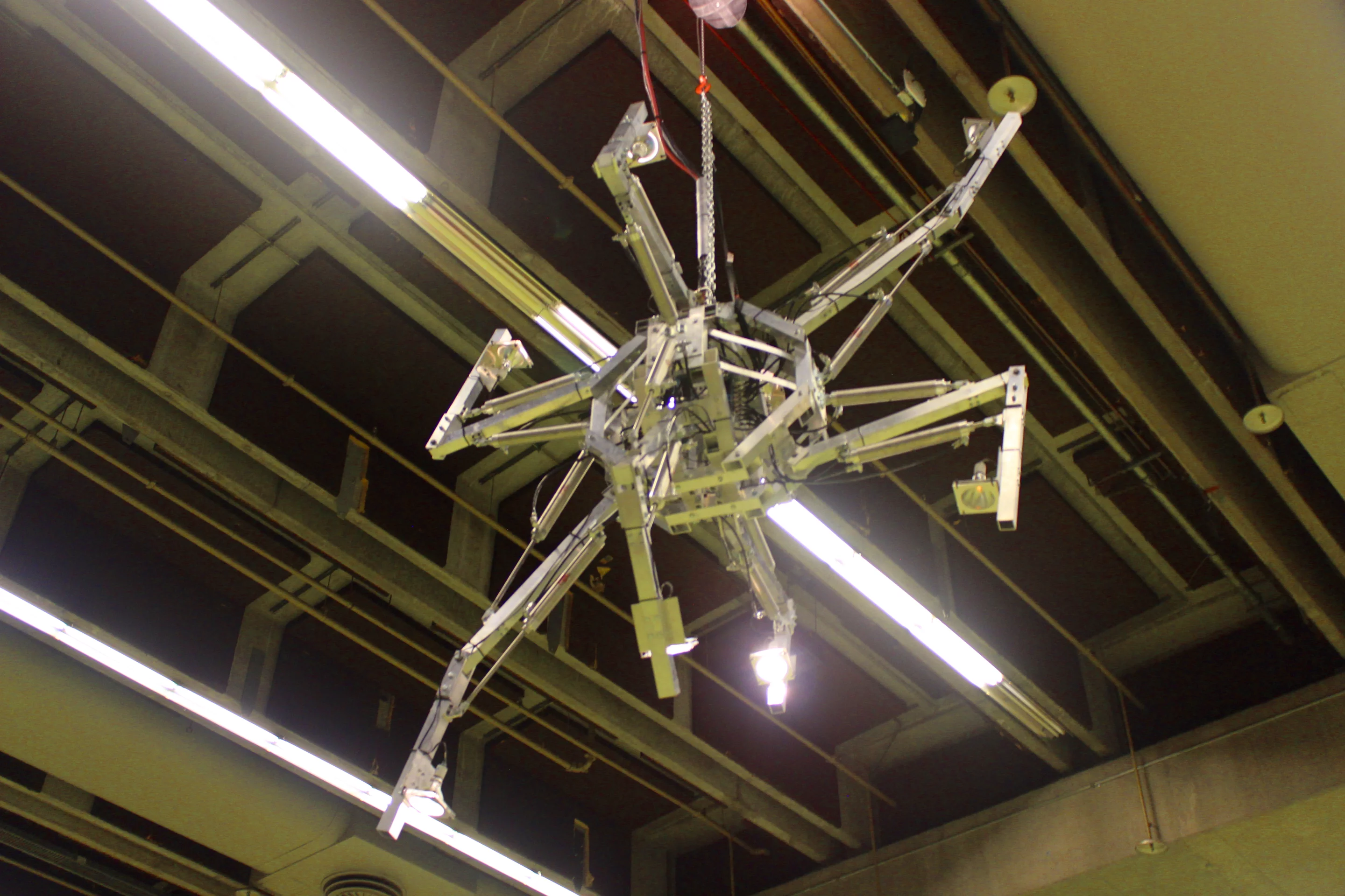 This eery, continually-moving sculpture hung from the ceiling – it's hard to see, but it has lights on the ends of its arms