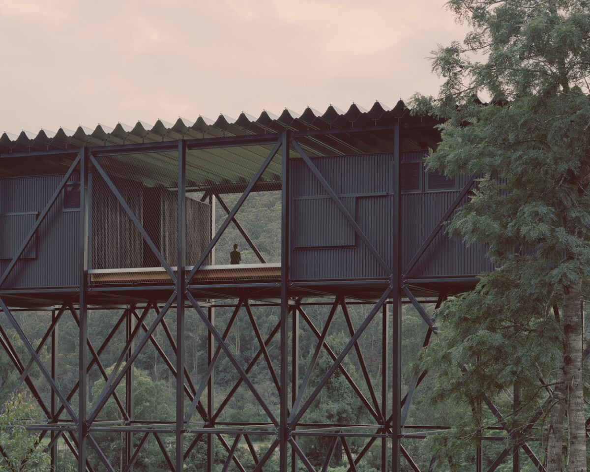 The design incorporates the use of black-stained timber and iconic rippled steel roofing