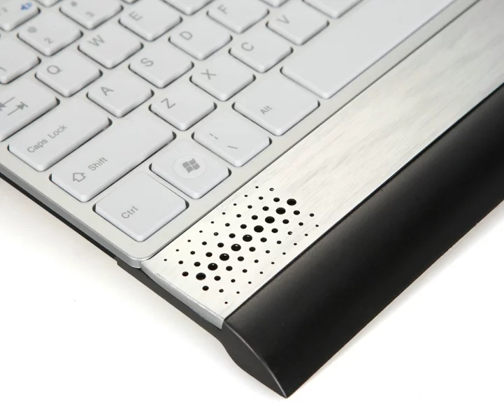 The full-size keyboard sports 104 chiclet-style keys, there's an integrated touchpad to the right, and stereo speakers rated at 0.7 W each below the main keying area
