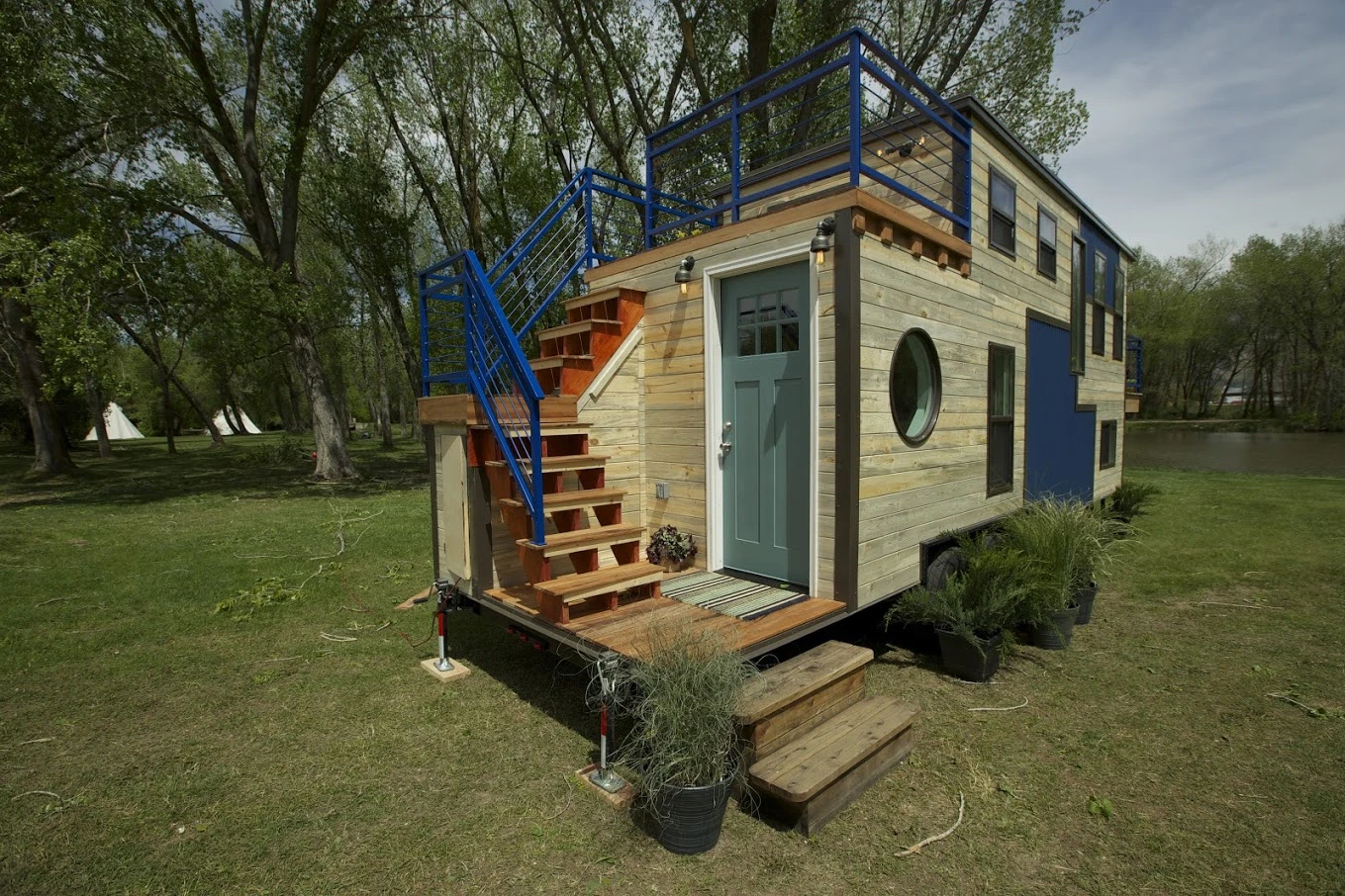 An exterior staircase allows the Tiny Ski Lodge's owners to access a second balcony area