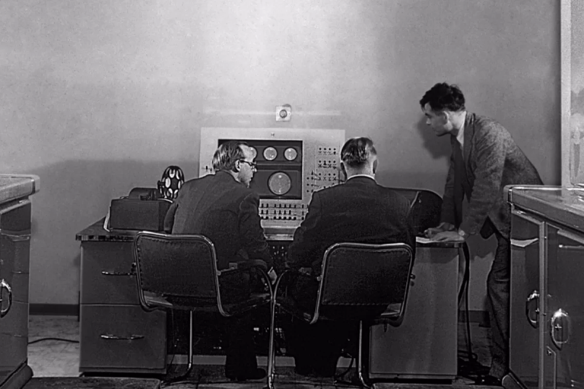 Turing (right) at the console of the Ferranti Mark I