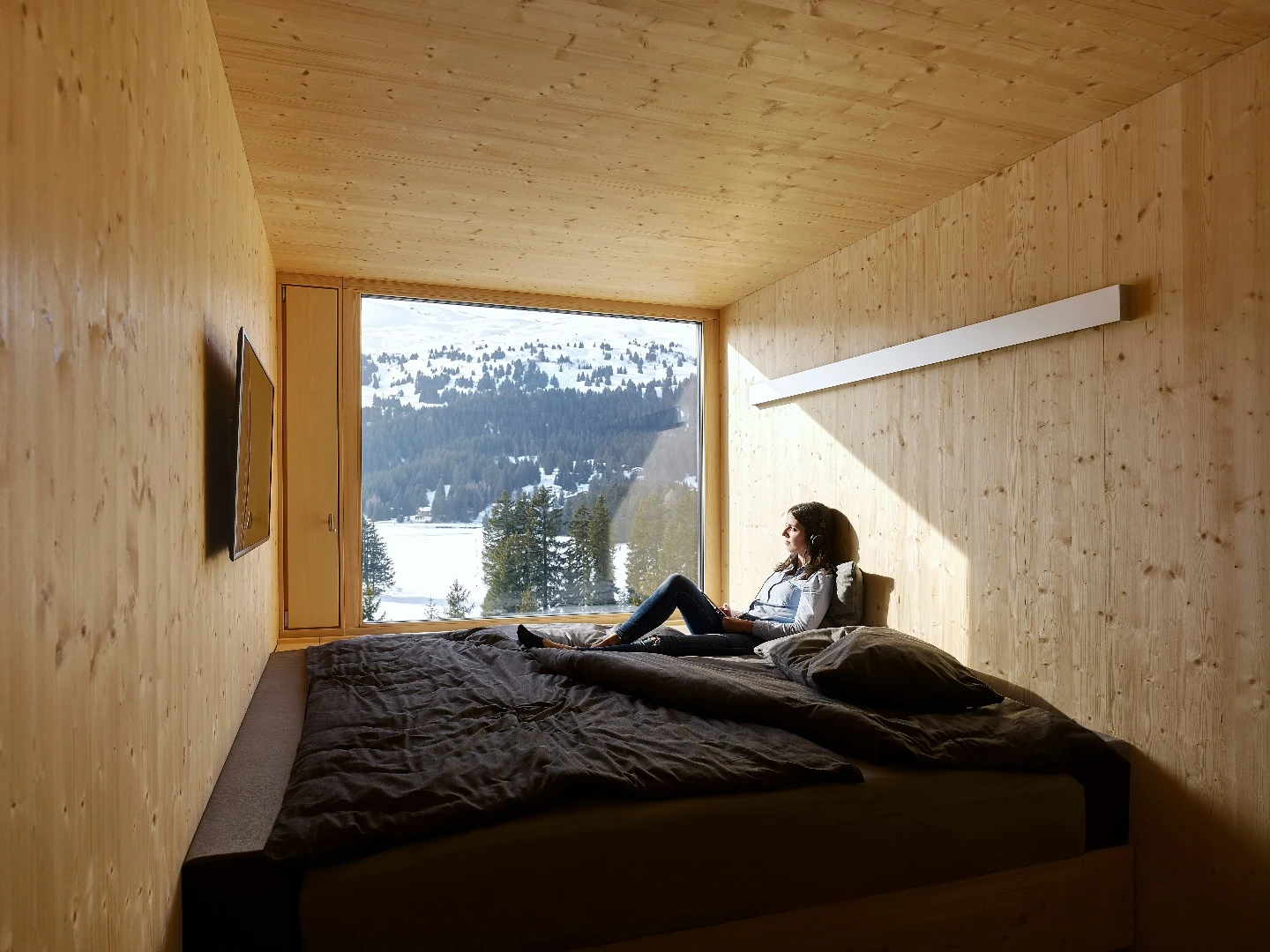 Each of the 96 rooms making up the four floors of the Revier Mountain Lodge was crafted from natural unfinished plywood and fabricated off site