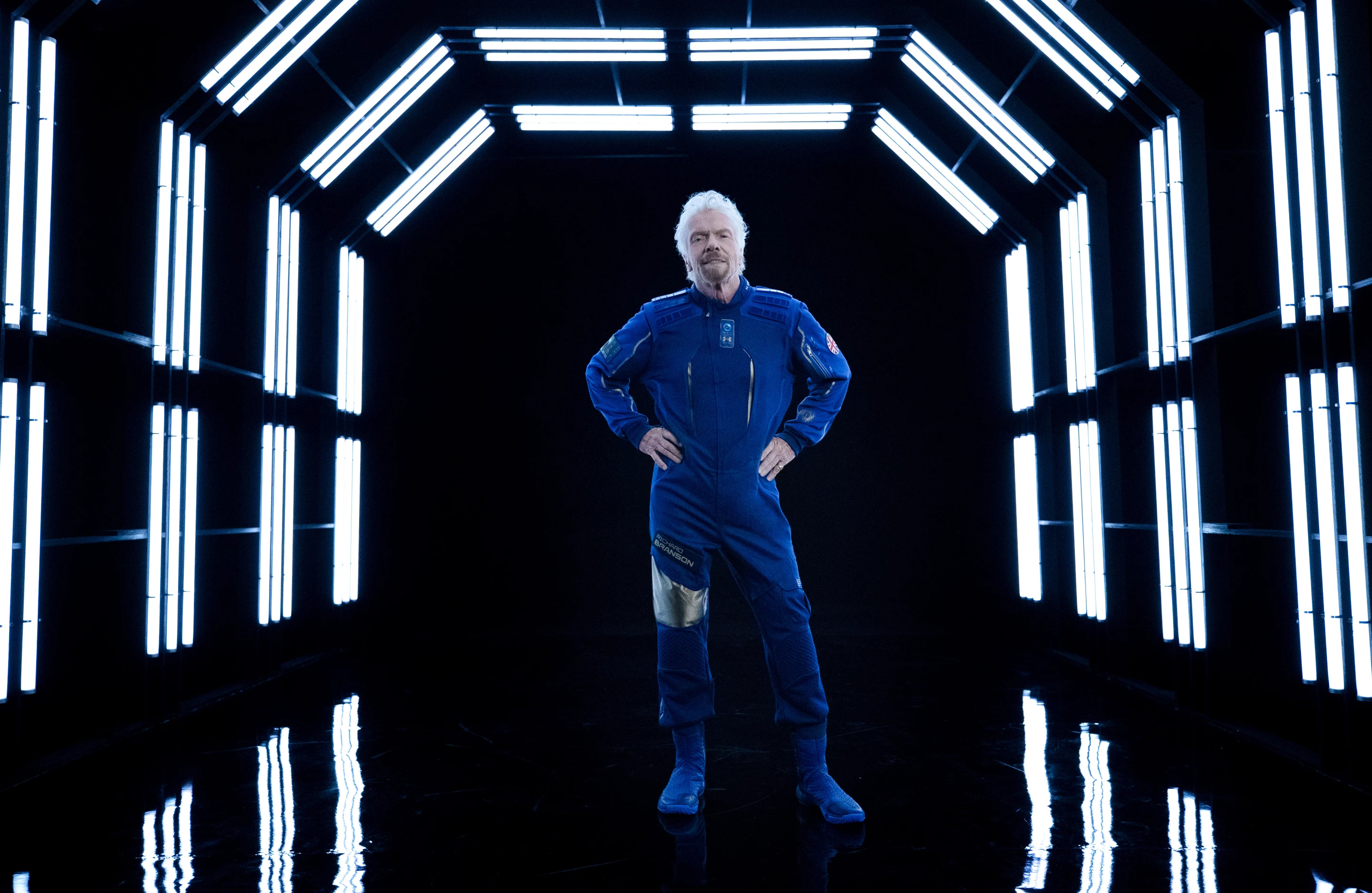 Sir Richard Branson modeling the suit he will wear for Virgin Galactic's inaugural flight
