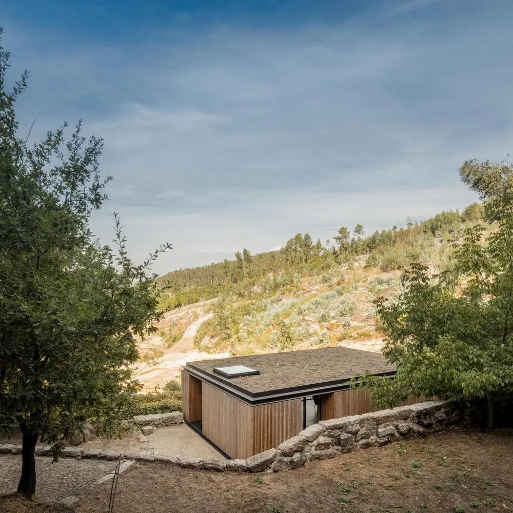 Pavilion House is a timber clad home built above a pre-existing wine cellar, located amid a stunning vineyard in Guimarães, Portugal