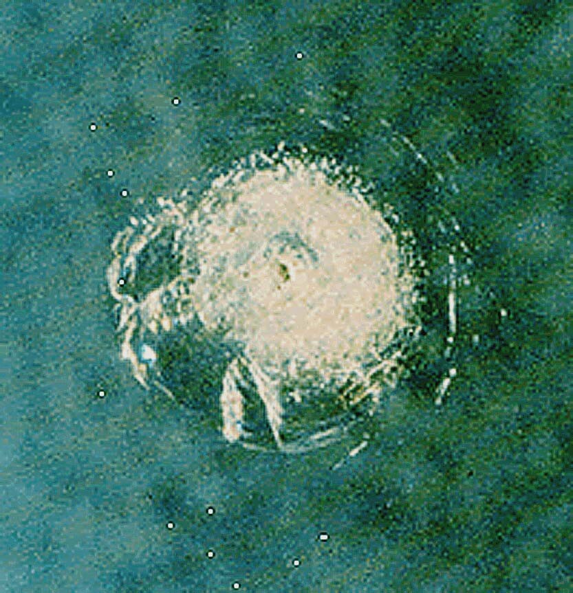 12mm crater on Shuttle windshield from impact of a 200 micron white paint chip (Photo: NASA)
