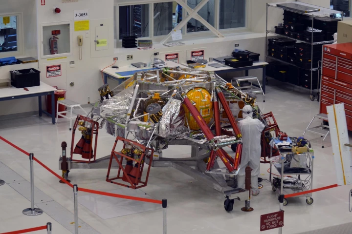 A technician works on the descent stage for NASA's Mars 2020 mission inside JPL's Spacecraft Assembly Facility