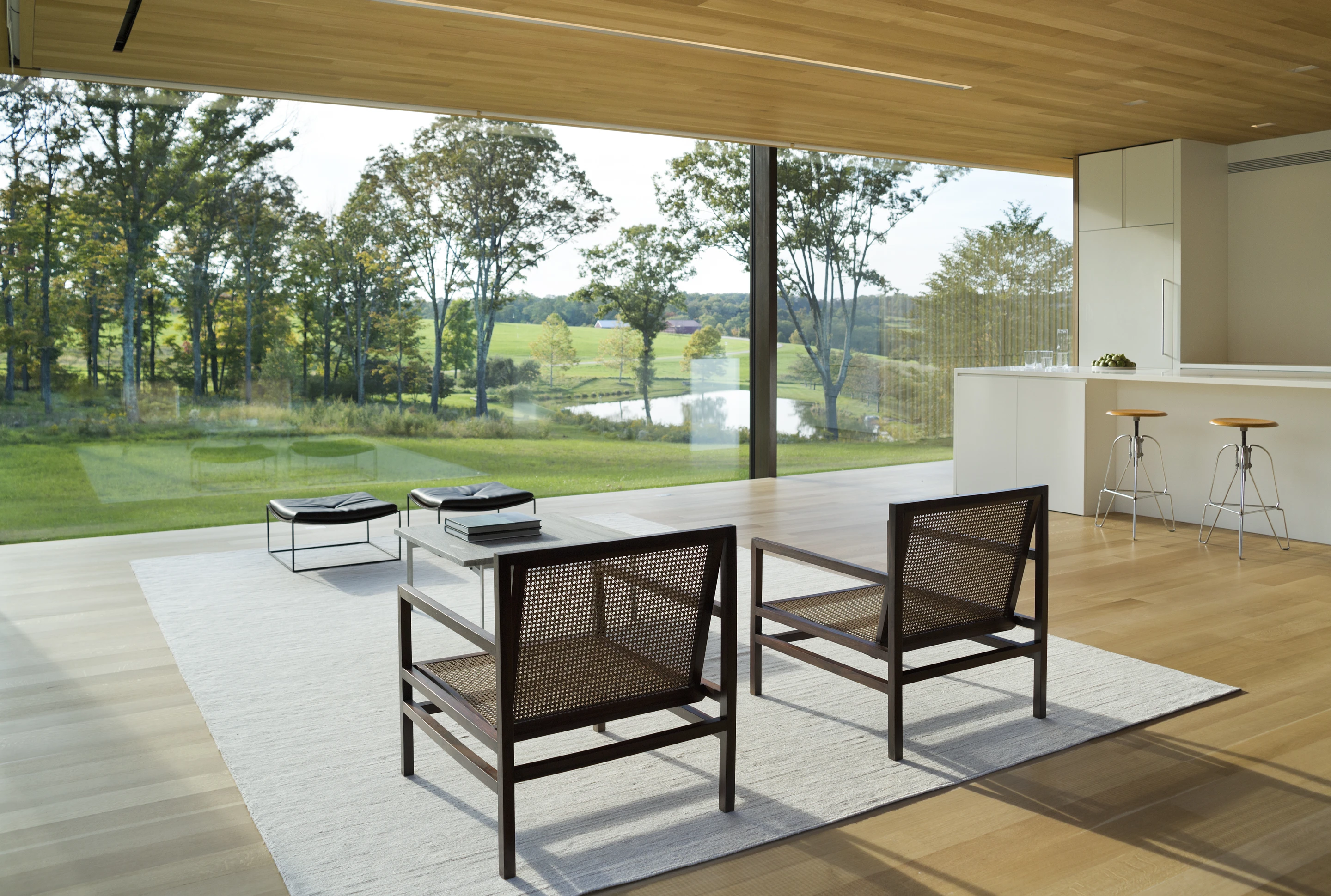 Located in Dutchess County, NY, this 2,000 square foot (185.6 sqm) country retreat captures extensive views across its landscape