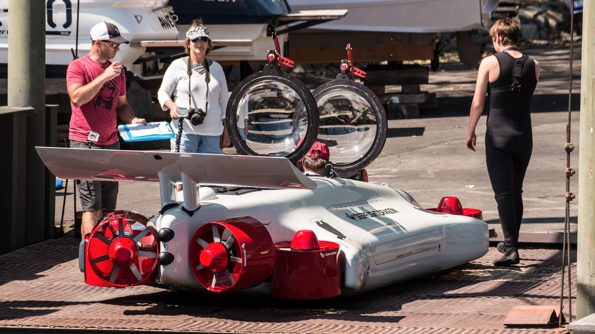Randall Fletcher, Karen Hawkes and Ollie Hawkes take the Deepflight Dragon through pre-flight checks.