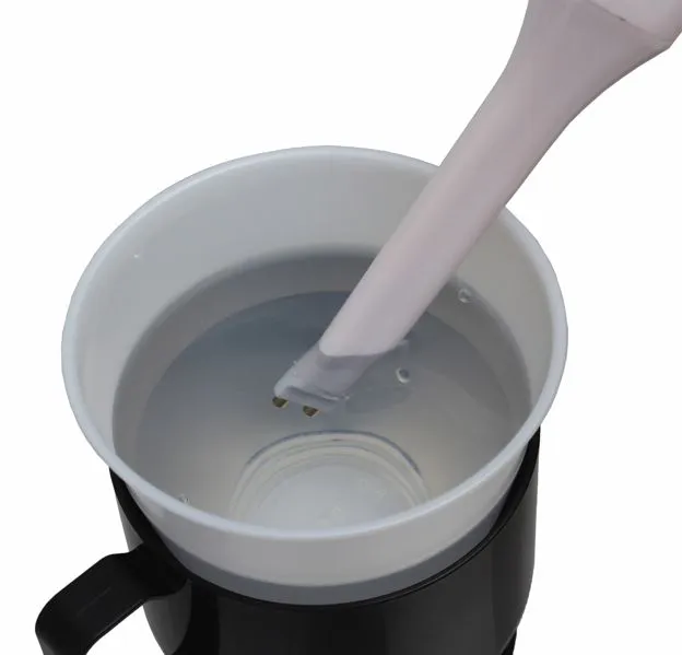 The device has a copper sensor at one end that the user lowers into a hot, liquid item